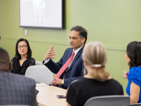 Suresh Garimella speaking with U of A colleagues