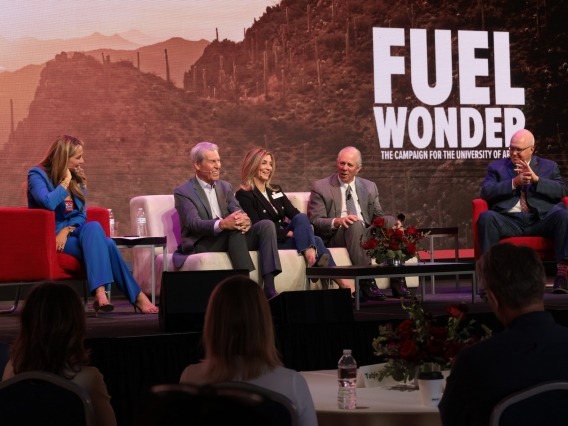five people sitting on a stage in front of a backdrop that says &quot;fuel wonder&quot;