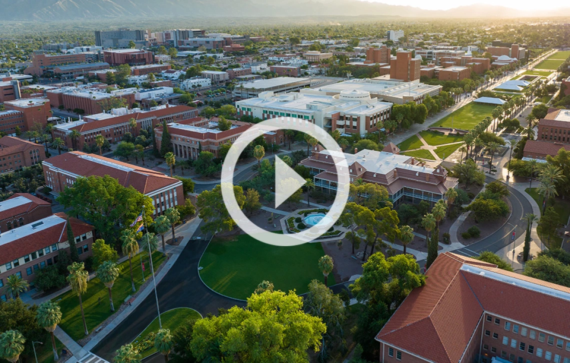 Aerial image of U of A campus with sunrise light shining on the mall and Old Main.