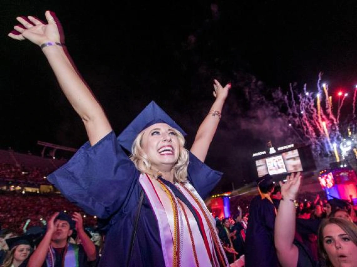 Katie Alhadeff, a business management graduate, celebrates at the close of the Commencement ceremony. 