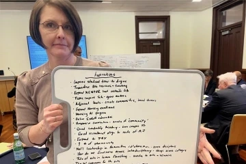 woman holding up a whiteboard